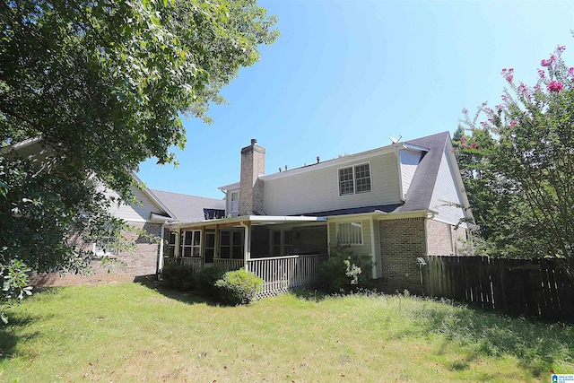 back of house with a lawn