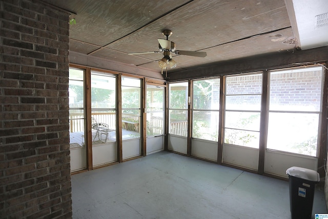 unfurnished sunroom featuring ceiling fan