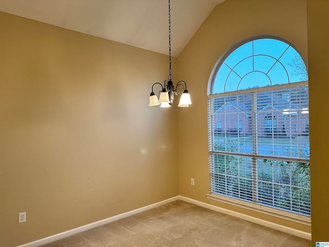 unfurnished room with carpet flooring, an inviting chandelier, and lofted ceiling