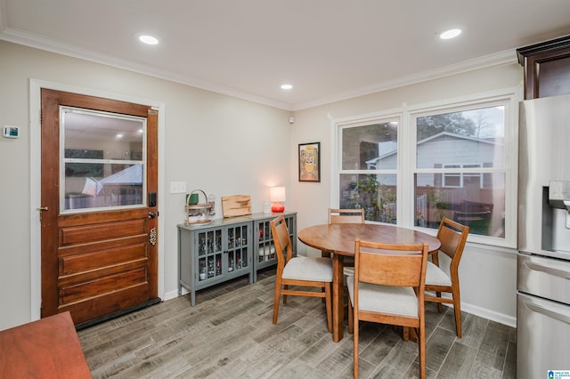 dining area with hardwood / wood-style floors and ornamental molding