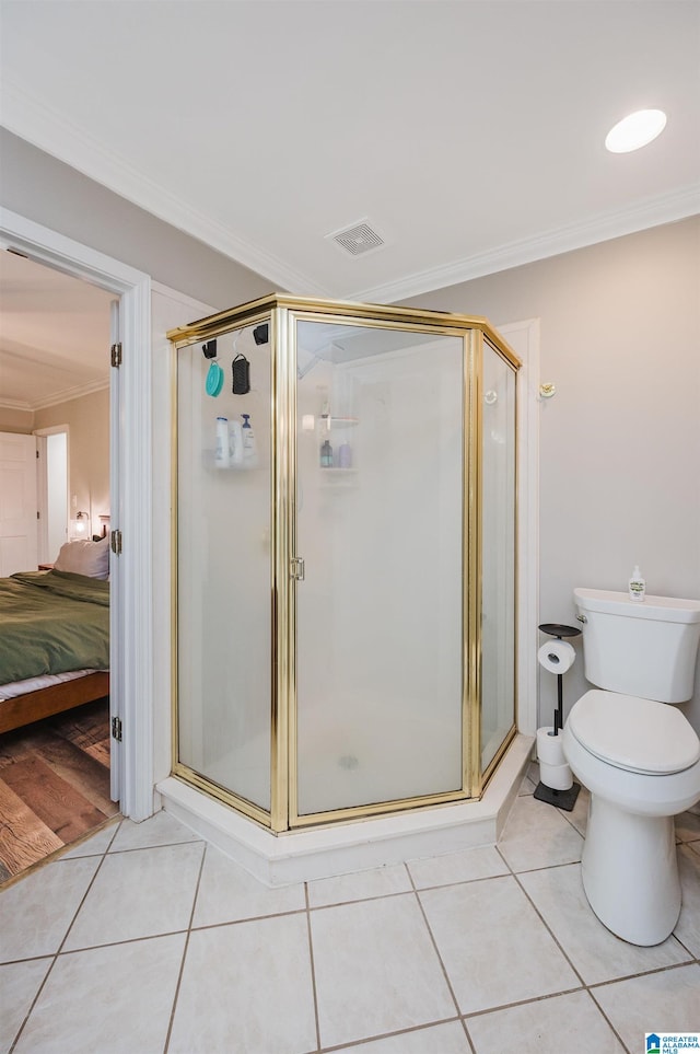 bathroom with toilet, tile patterned flooring, an enclosed shower, and ornamental molding