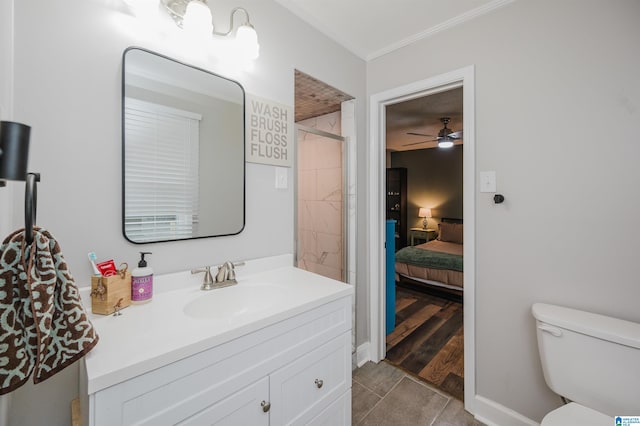 bathroom featuring a tile shower, vanity, ceiling fan, wood-type flooring, and toilet