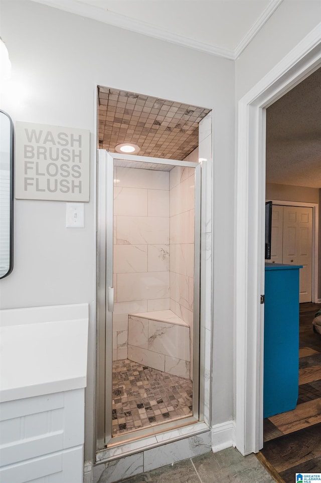 bathroom with hardwood / wood-style flooring and walk in shower