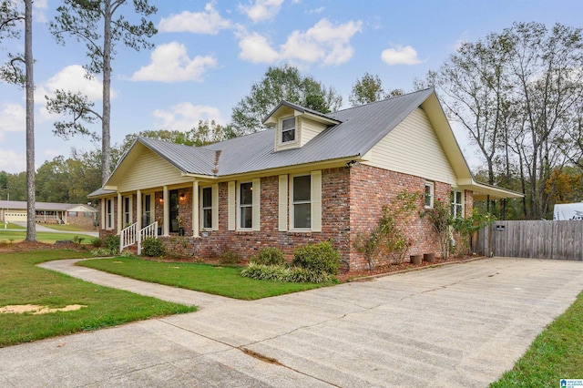 view of front of property with a porch and a front lawn