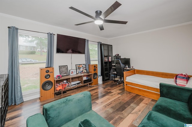 bedroom with multiple windows, ceiling fan, and hardwood / wood-style floors