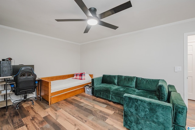 interior space with hardwood / wood-style flooring, ceiling fan, and ornamental molding