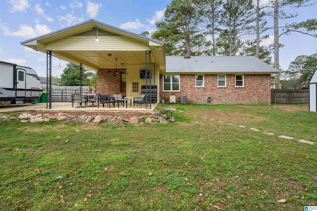 back of house featuring a lawn and a patio