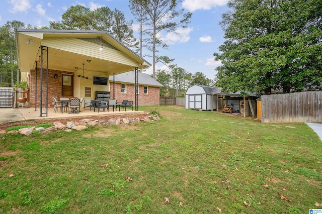 view of yard with a shed and a patio area