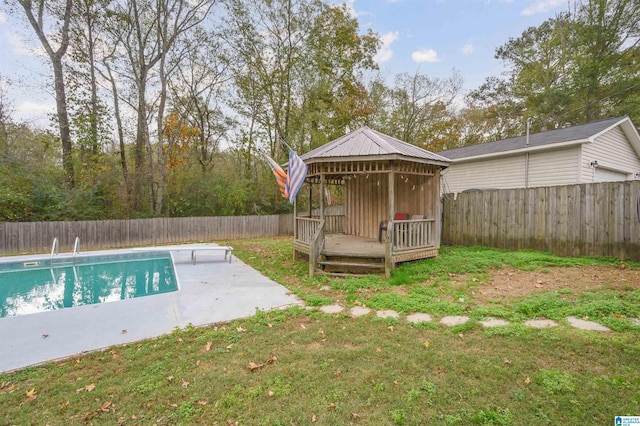 view of pool with a gazebo, a wooden deck, a lawn, and a patio