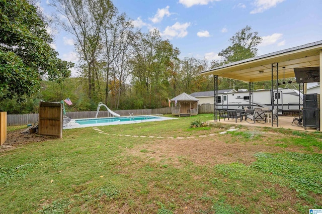 view of yard featuring a fenced in pool and a patio