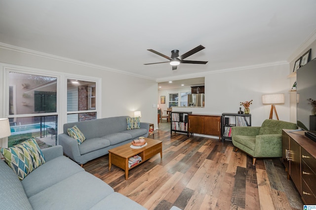 living room featuring ceiling fan, hardwood / wood-style floors, and ornamental molding