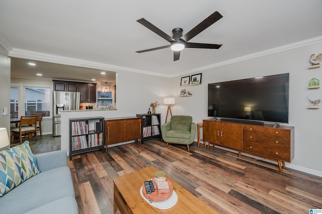 living room with ceiling fan, dark hardwood / wood-style flooring, and ornamental molding