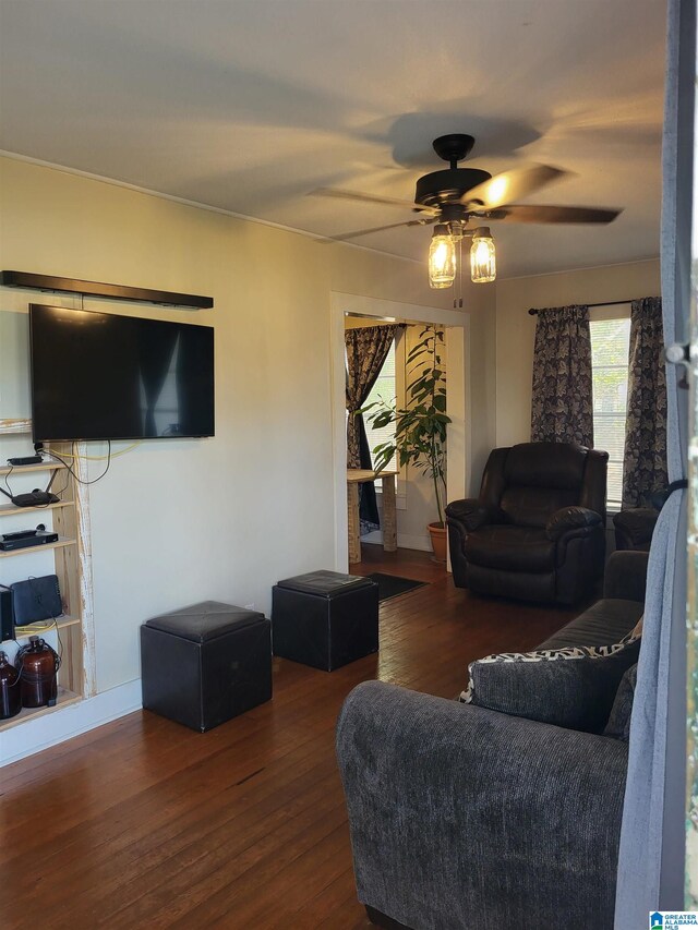 living room with ceiling fan, plenty of natural light, and dark hardwood / wood-style floors