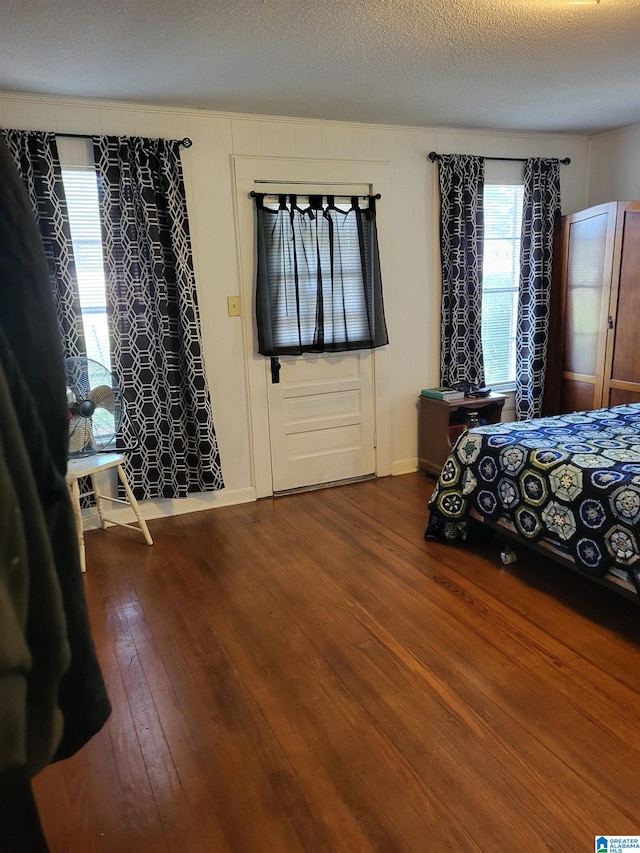 unfurnished bedroom with hardwood / wood-style floors and a textured ceiling