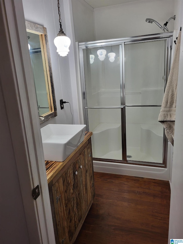 bathroom featuring a shower with door, vanity, and hardwood / wood-style floors