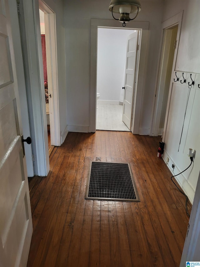 hall with dark hardwood / wood-style flooring