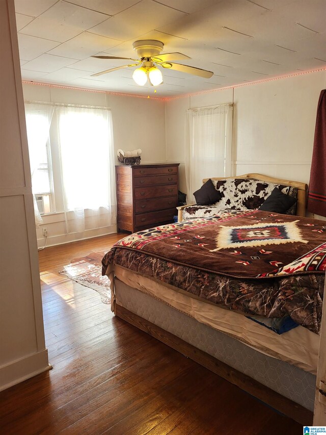 bedroom with hardwood / wood-style flooring and ceiling fan