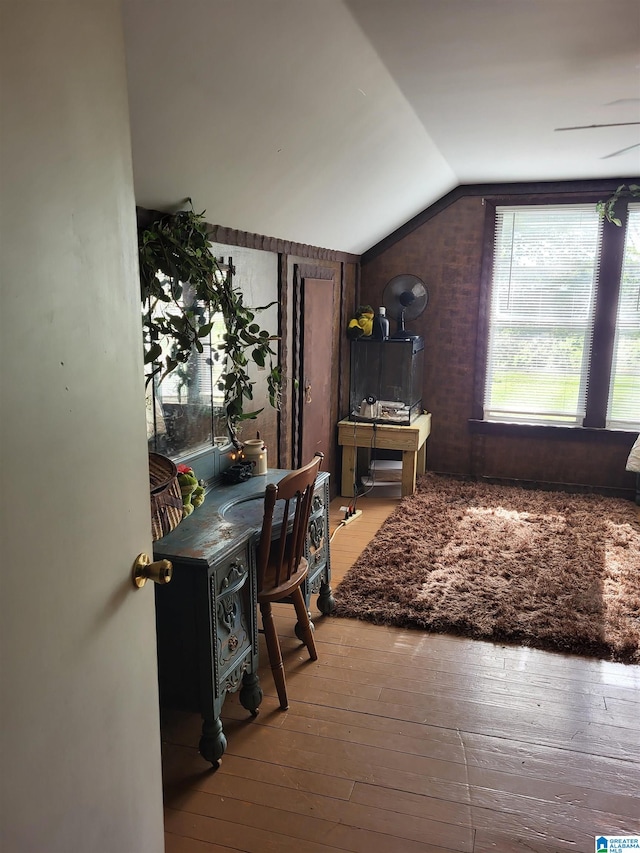 interior space featuring light hardwood / wood-style floors and lofted ceiling