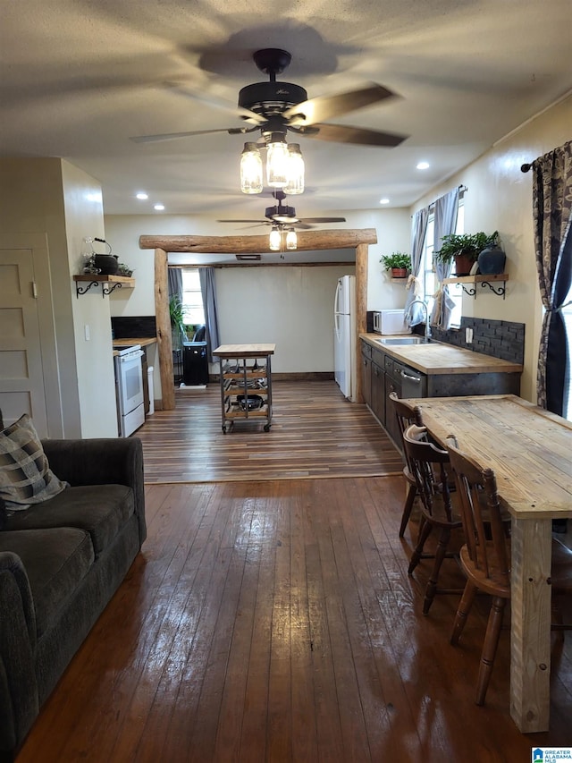 dining room featuring ceiling fan, dark hardwood / wood-style flooring, and sink