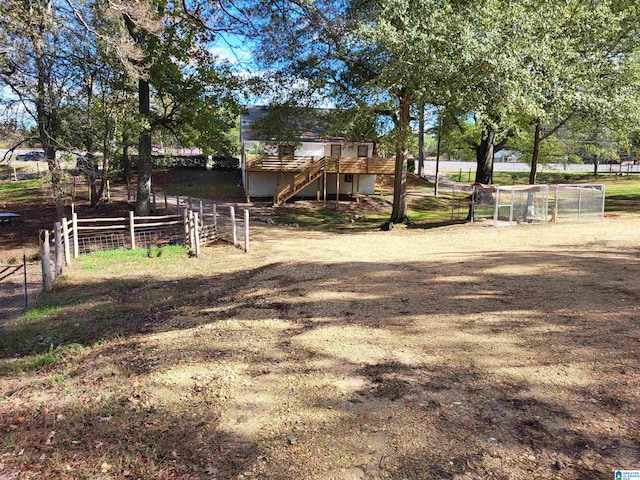 view of yard with a wooden deck and a rural view