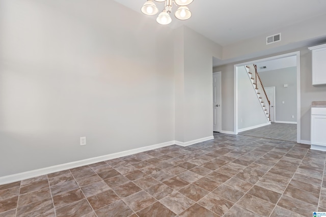 empty room with a notable chandelier