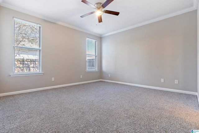 carpeted empty room featuring a wealth of natural light, crown molding, and ceiling fan