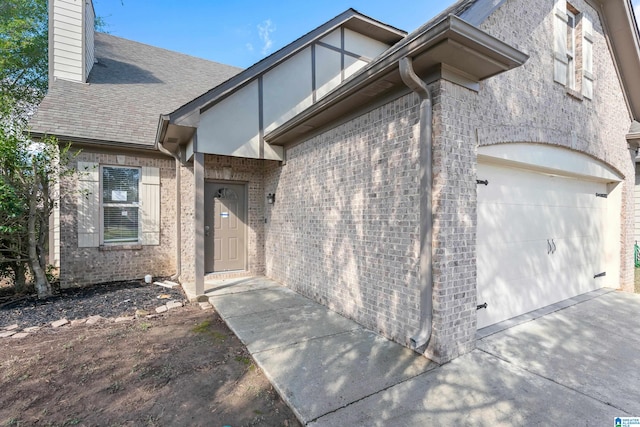 view of exterior entry featuring a garage