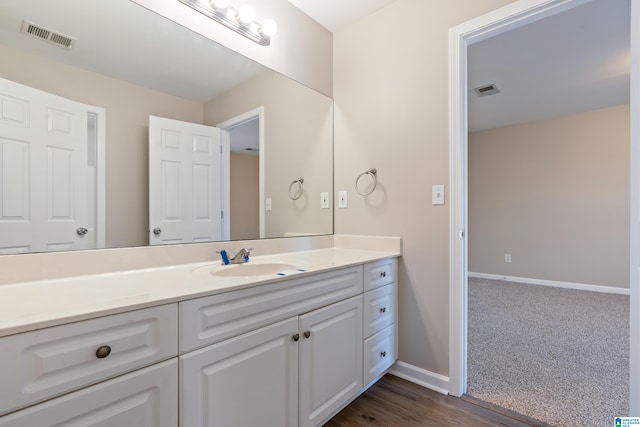 bathroom with hardwood / wood-style floors and vanity