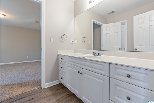 bathroom featuring wood-type flooring and vanity