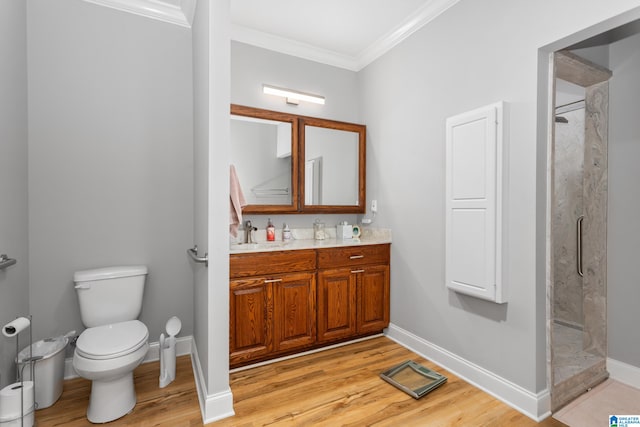 bathroom featuring vanity, crown molding, a shower, and hardwood / wood-style flooring