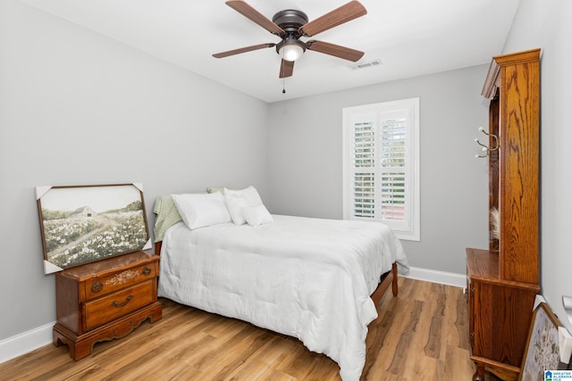 bedroom with light wood-type flooring and ceiling fan