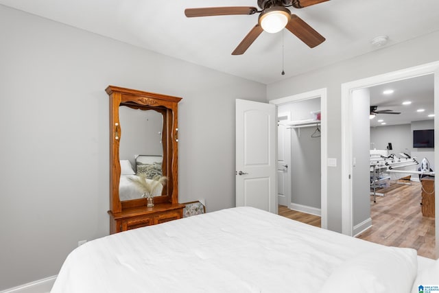 bedroom featuring ceiling fan, light hardwood / wood-style floors, and a closet