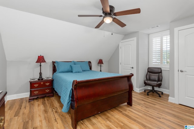 bedroom featuring light wood-type flooring, ceiling fan, and lofted ceiling