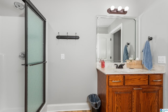 bathroom featuring hardwood / wood-style floors, vanity, and an enclosed shower