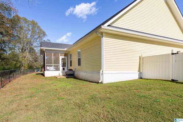 view of property exterior featuring a sunroom and a lawn