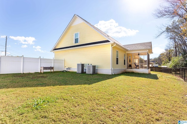 back of property featuring a lawn, central AC, and ceiling fan