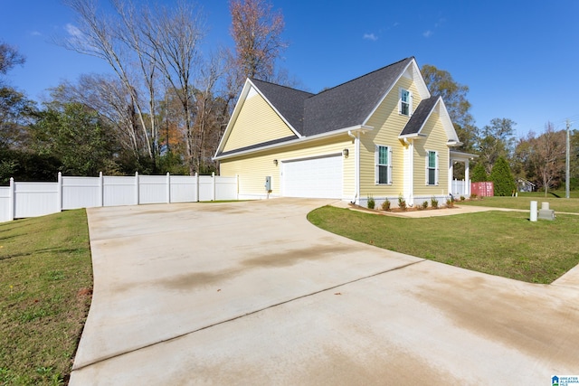 view of side of property with a lawn and a garage