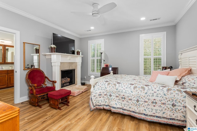 bedroom featuring ceiling fan, light wood-type flooring, crown molding, and multiple windows