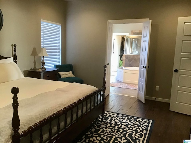 bedroom with dark hardwood / wood-style flooring and ensuite bath