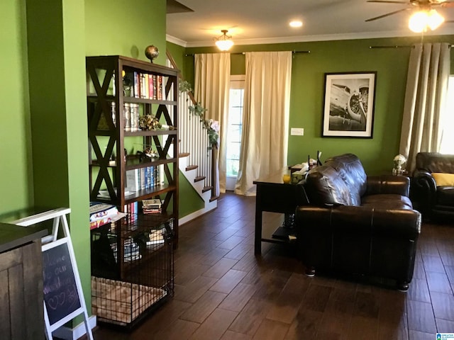 interior space featuring dark hardwood / wood-style floors, ceiling fan, and ornamental molding