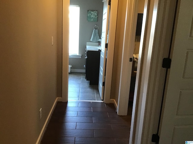 corridor featuring dark hardwood / wood-style flooring