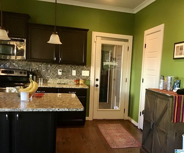 kitchen with pendant lighting, dark hardwood / wood-style floors, light stone countertops, tasteful backsplash, and stainless steel appliances