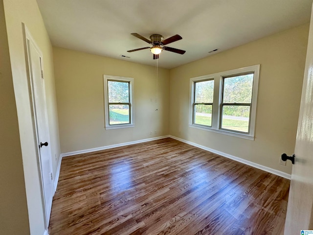 empty room featuring hardwood / wood-style floors, plenty of natural light, and ceiling fan