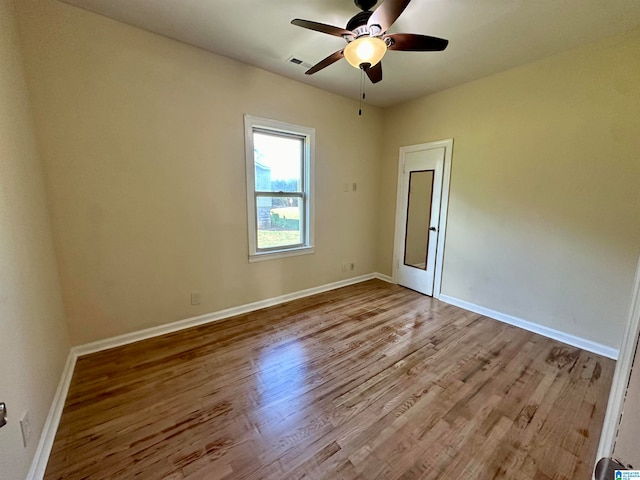 spare room featuring light hardwood / wood-style floors and ceiling fan