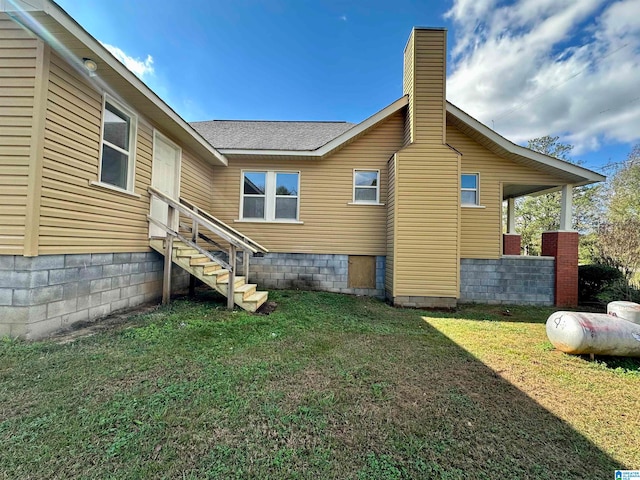 rear view of property with a lawn