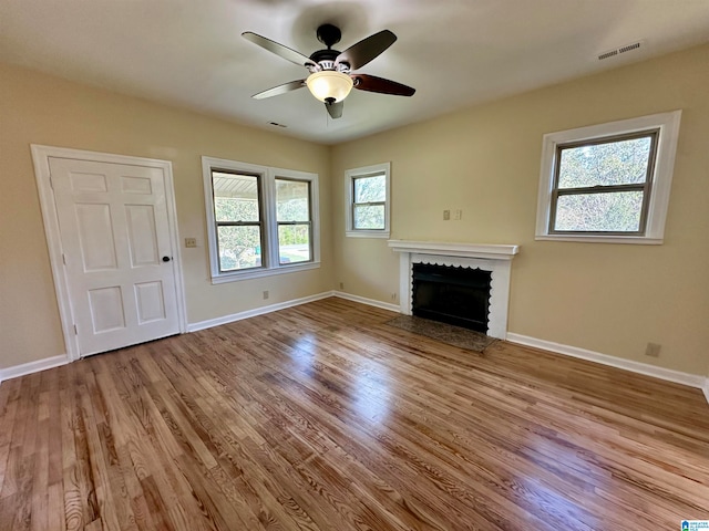 unfurnished living room with ceiling fan and light hardwood / wood-style flooring