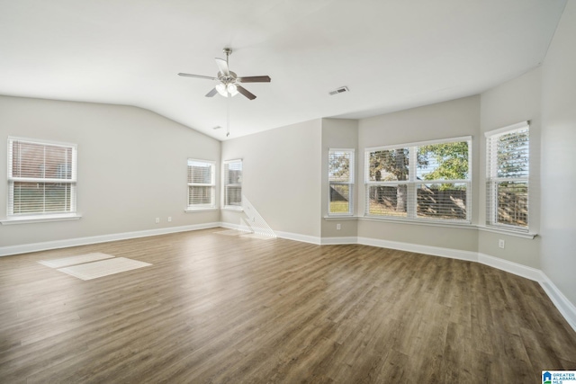 unfurnished living room with vaulted ceiling, ceiling fan, and dark wood-type flooring