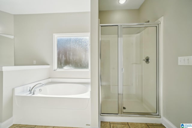 bathroom featuring independent shower and bath