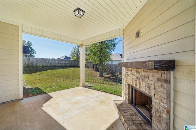 view of patio featuring an outdoor stone fireplace