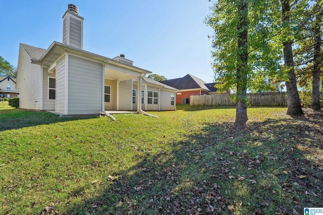 rear view of house with a yard